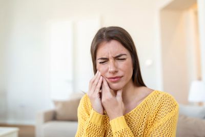 woman holding her face with toothache